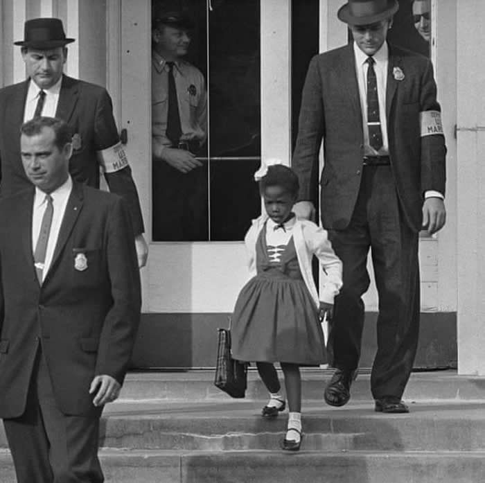 6-year-old Ruby Bridges, flanked by U.S. Marshals, integrates a Southern school in 1960.
